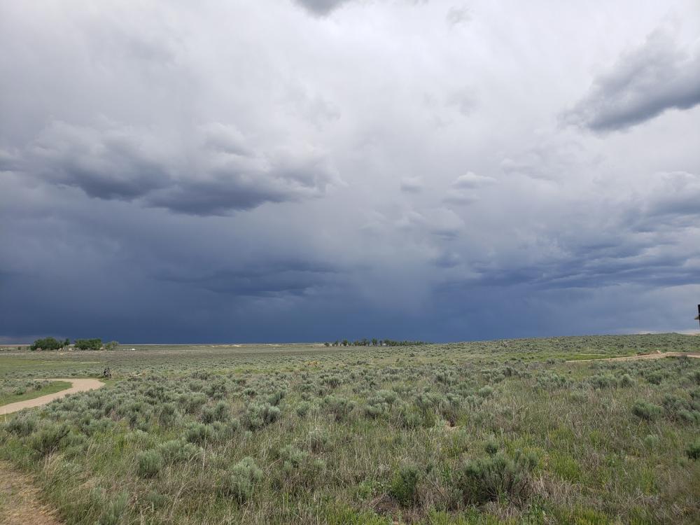 Dark cloudy skies over grassland at Sand Creek Massacre National Historic Site, Colorado