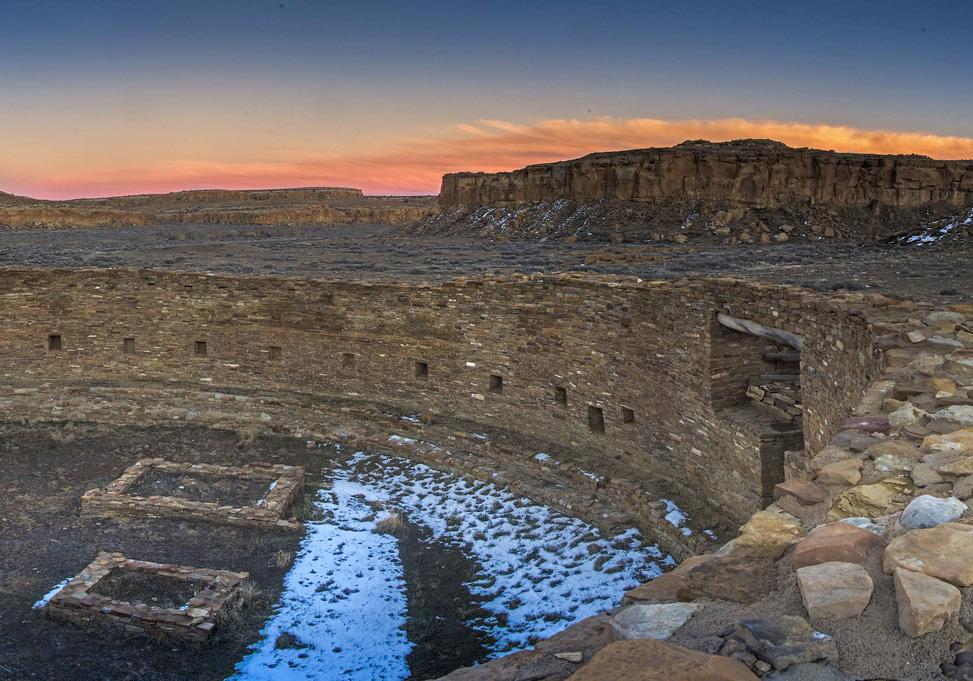 A view of the Chaco Canyon ruins with the sunset on the background.