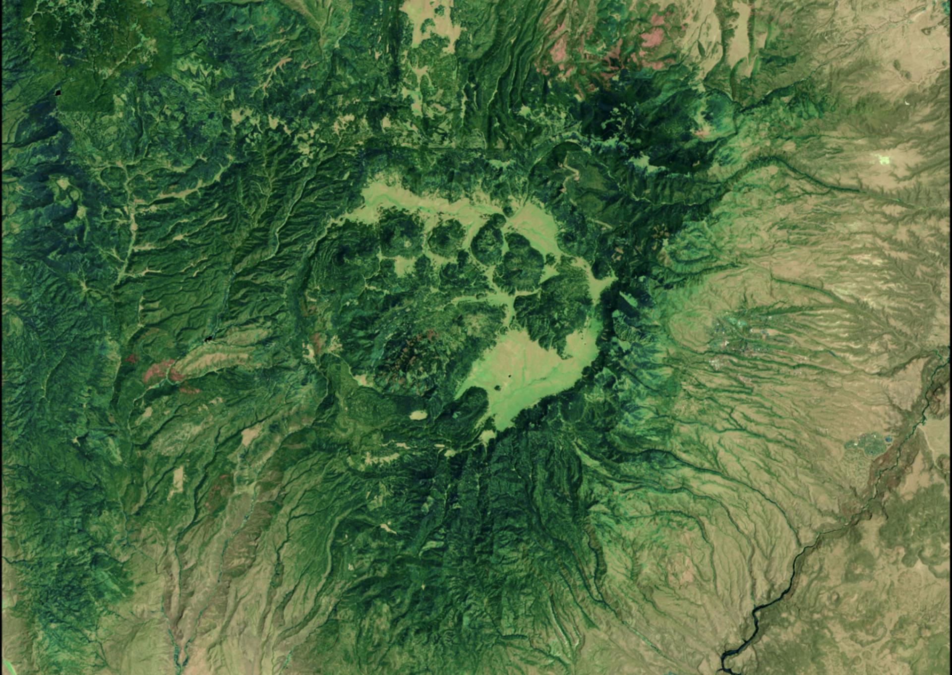 Aerial satellite image of green-tinged terrain showing Santa Fe National Forest on June 24, 2011, before the Las Conchas Fire