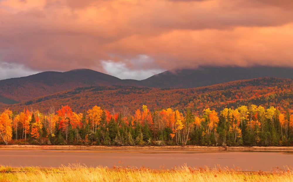 Fall foliage and mountains in the High Peaks region of Maine.