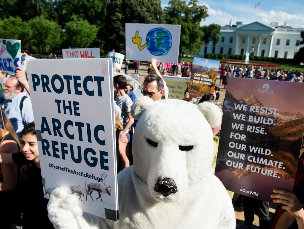 Environmental activists protest in front of the White House after President Donald Trump announced he is withdrawing the United States from the Paris climate accord on Thursday, June 1, 2017.