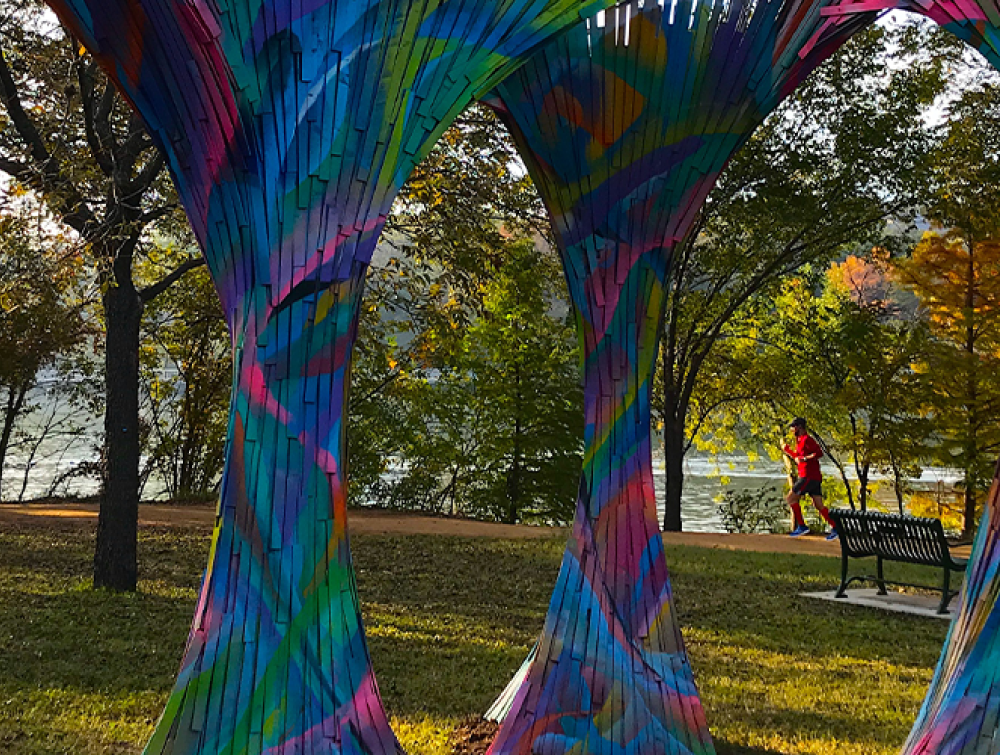 A picture of three multicolored art sculptures that look like trees.