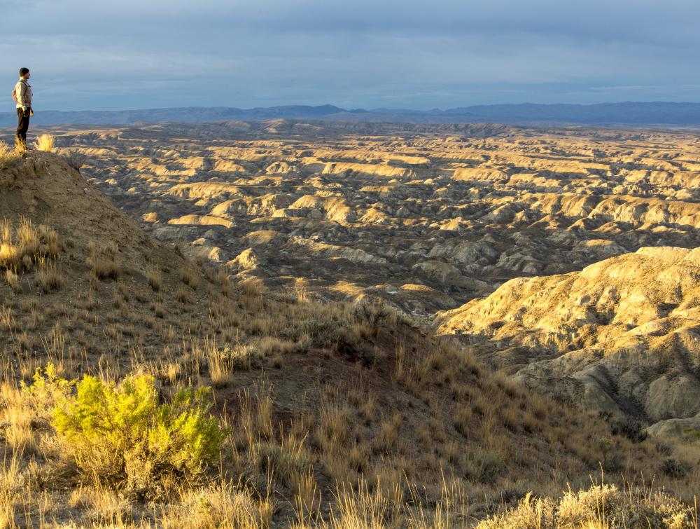 A person enjoys the open skies and stretching vistas of the Honeycomb Wilderness Study Area in Wyoming. 