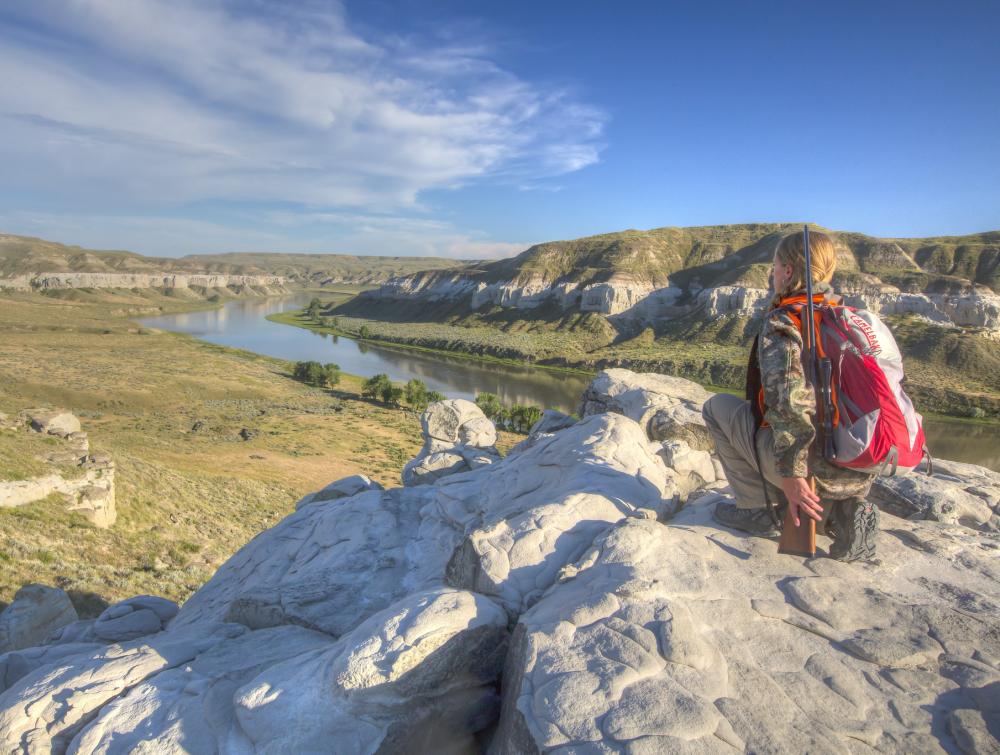 hunter looks over mountain and river