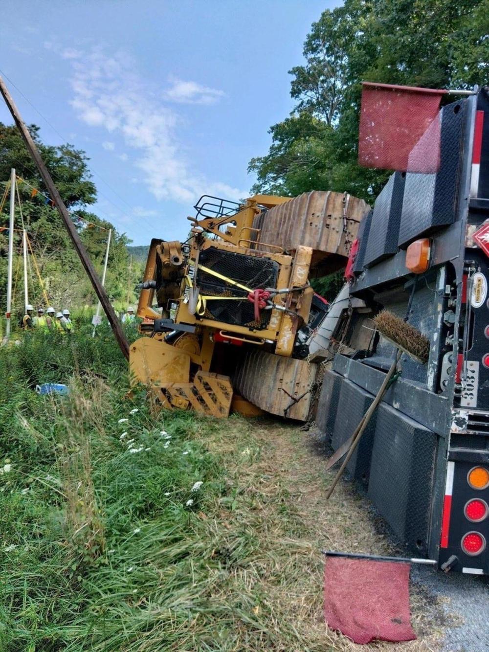 An excavator lays flipped on its side