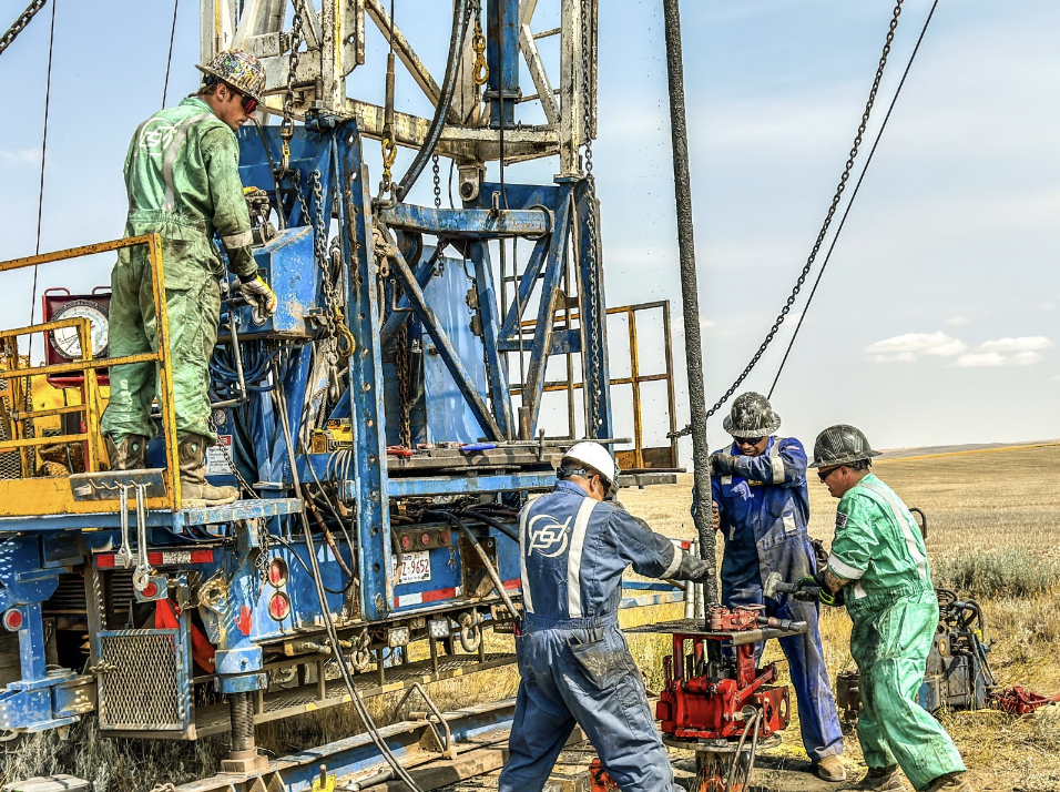 a team of people use equipment to plug an oil and gas well