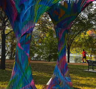 A picture of three multicolored art sculptures that look like trees.