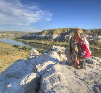 hunter looks over mountain and river