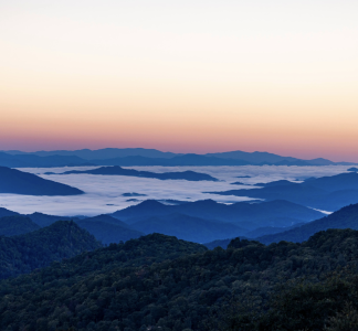 sunrise on top of mountains with clouds