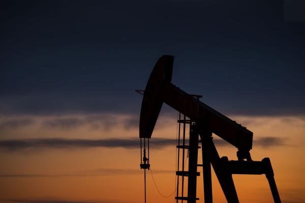 dark outline of oil rig in the sunset in Pawnee National Grasslands, CO